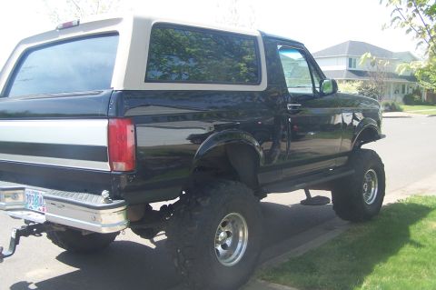 1995 Ford Bronco - This lifted Ford Bronco has a two-tone paint job and large off-road tires.