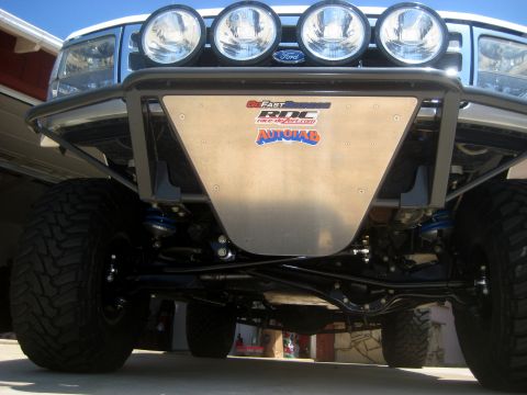 1996 Ford Bronco - Front view of a 1996 Ford Bronco, its lifted suspension, off-road tires, and custom bumper with sponsor decals.