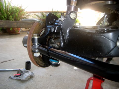 1996 Ford Bronco - The photo shows a close-up view of the steering and suspension system of a vehicle, with a brake rotor and caliper visible.