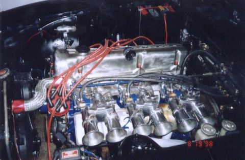1971 Nissan 240SX - Close-up of a modified engine multiple carburetors and a polished intake manifold.
