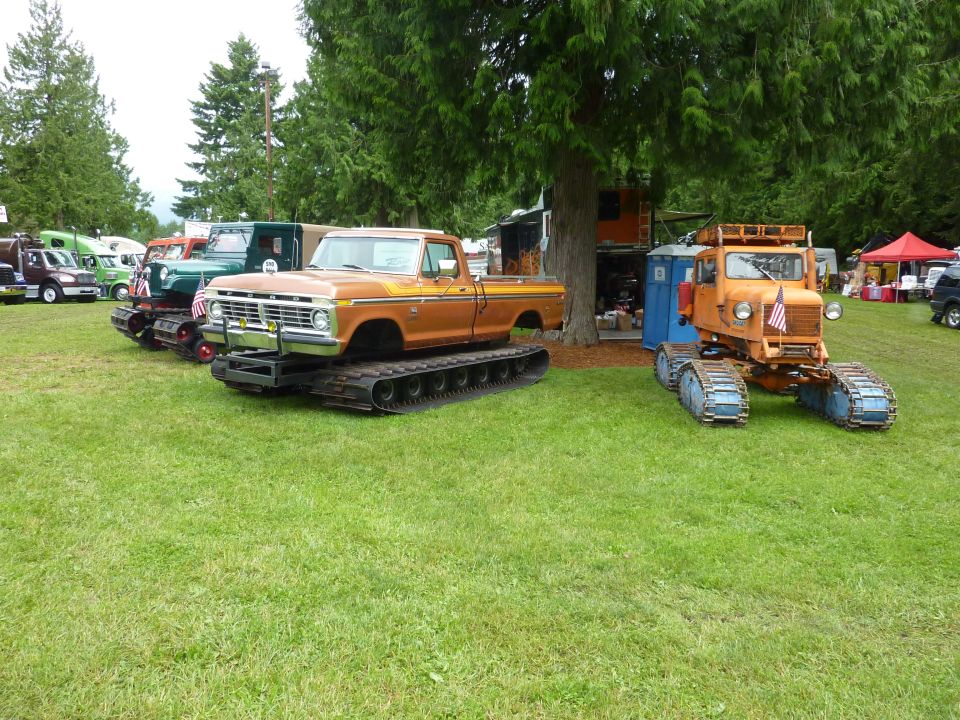 Orange pickup truck with tracks, front view