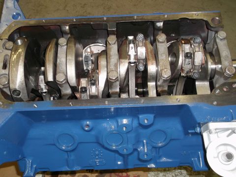 1967 Ford Mustang - Close-up view of the internal components of an engine, showing the crankshaft and connecting rods.