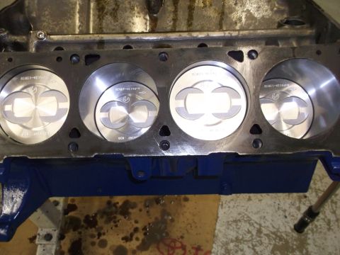 1967 Ford Mustang - Close-up view of an engine block revealing four pistons and cylinder bores.