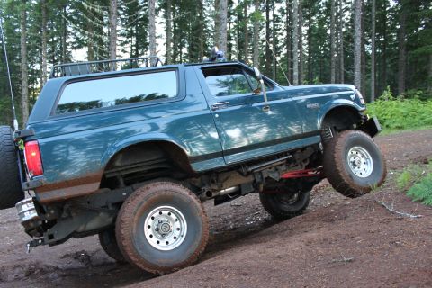 1995 Ford Bronco - This 1995 Ford Bronco is captured mid-climb on a dirt trail, its off-road capabilities.
