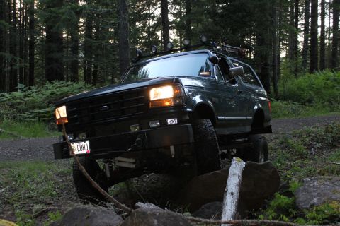 1995 Ford Bronco - This 1995 Ford Bronco is navigating a rocky path through a forest.