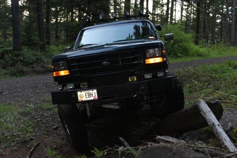 1995 Ford Bronco - This modified Ford Bronco navigates a rocky trail in a wooded area.