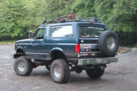 1995 Ford Bronco - Modified 1995 Ford Bronco parked outdoors with a spare tire mounted on the rear.