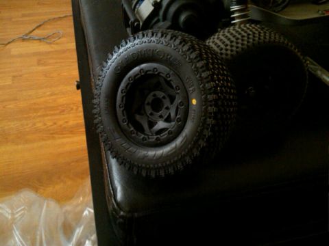 1986 Ford Bronco - Close-up of RC car tires and suspension parts, not a 1986 Ford Bronco.