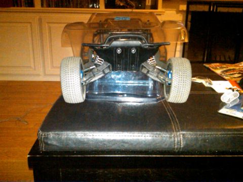 1986 Ford Bronco - The rear suspension and wheels of an RC car are shown, with a clear body shell over the chassis.