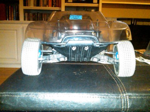 1986 Ford Bronco - A clear plastic body remote control car is shown from the rear, resting on a dark surface.