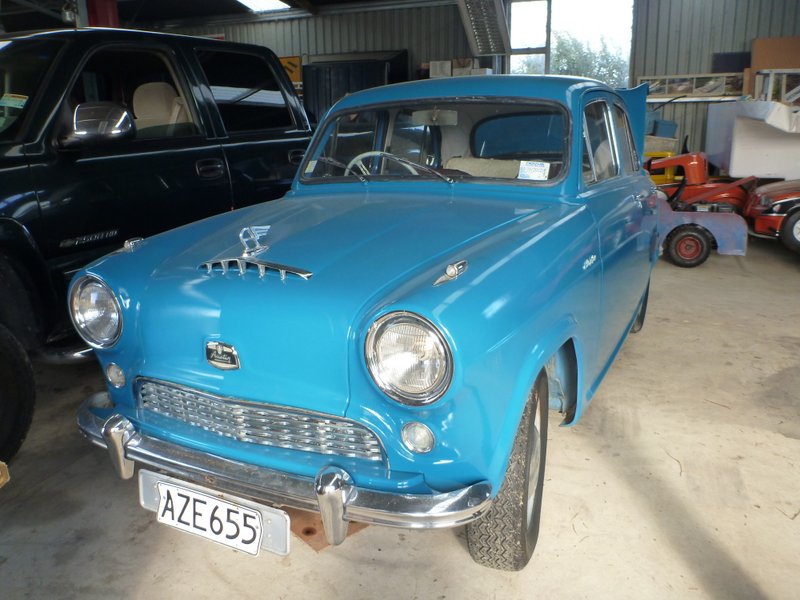 Blue sedan with chrome grille and hood ornament. License plate AZ E655