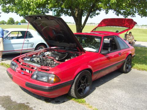 2007 Ford Mustang - A red 1987 Ford Mustang coupe is displayed with its hood and trunk open, revealing the engine bay.