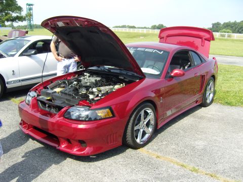 2007 Ford Mustang - Red Saleen Mustang with hood and trunk open, parked next to a white Ford Mustang GT500.