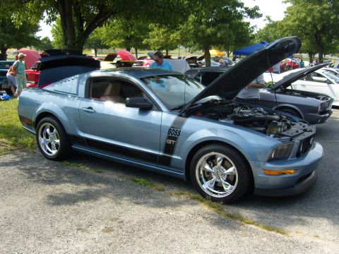 2007 Ford Mustang - Blue 2007 Ford Mustang GT with BOSS 302 stripe, hood open, at a car show.