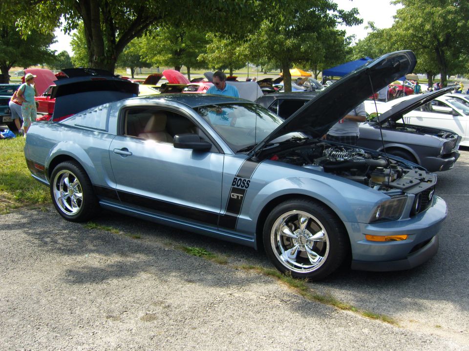 Blue 2007 Ford Mustang GT with BOSS 302 stripe, hood open, parked at car show