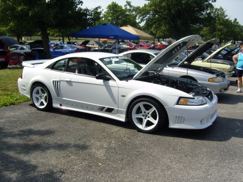 2007 Ford Mustang - A white Saleen S281 Extreme is displayed at an outdoor car show with its hood open.