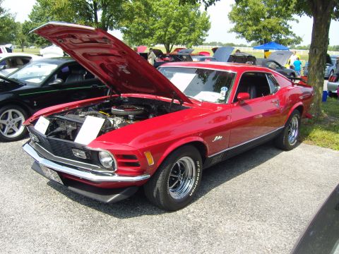 2007 Ford Mustang - This classic red 1970 Ford Mustang is displayed with its hood open at an outdoor car show.