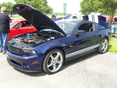 2007 Ford Mustang - A blue Ford Mustang with its hood and trunk open is displayed at an outdoor event.