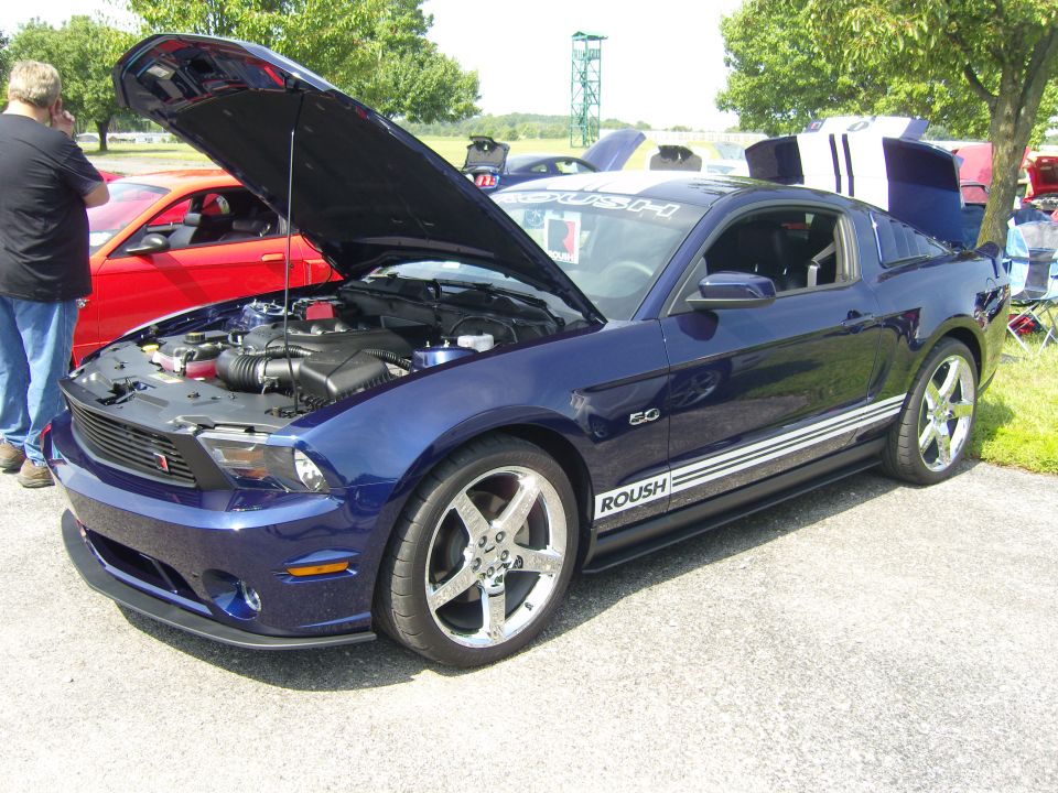 Blue 2010 Ford Mustang with hood and trunk open, Roush badging, and racing stripes