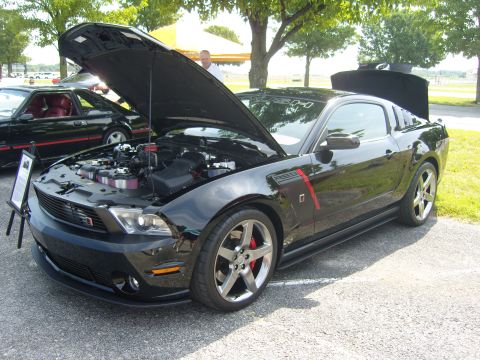 2007 Ford Mustang - A black 2007 Ford Mustang is displayed with its hood and trunk open, revealing the engine and interior details.