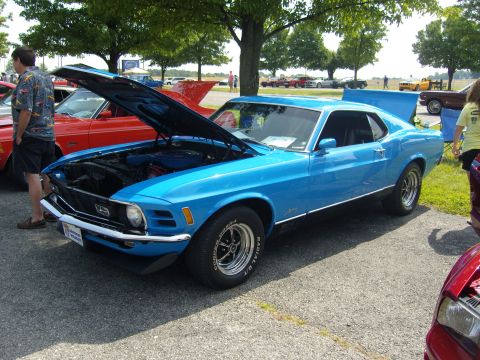 2007 Ford Mustang - A blue classic car is displayed with its hood open at an outdoor car show.