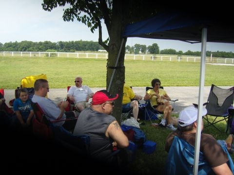 2007 Ford Mustang - Spectators relax in lawn chairs under a canopy at an outdoor event.