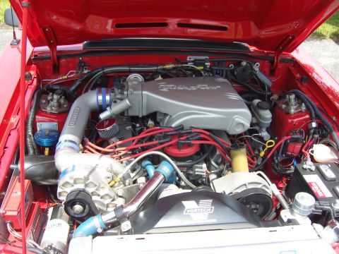 2007 Ford Mustang - Close-up of a modified engine bay a Vortech supercharger and custom intake system.