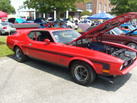 2007 Ford Mustang - Red 1971 Ford Mustang Mach 1 on display at a car show with other vehicles.