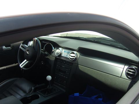 2007 Ford Mustang - The interior of a 2007 Ford Mustang is visible, the dashboard and driver's controls.
