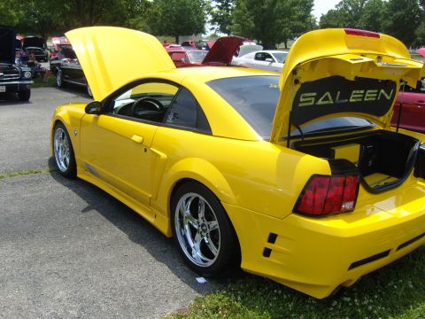 2007 Ford Mustang - A yellow 2007 Ford Mustang with its hood and trunk open, displaying the Saleen logo in the trunk.