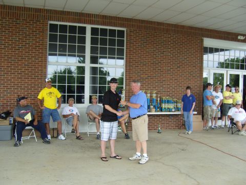 2007 Ford Mustang - A trophy presentation ceremony is underway with participants and spectators gathered.
