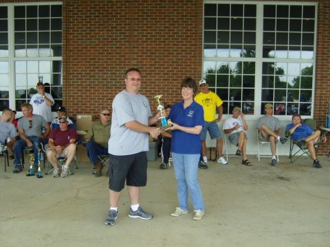 2007 Ford Mustang - A man hands a trophy to a woman while others observe at an outdoor event.