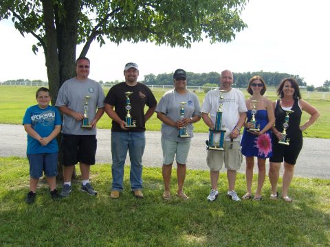 2007 Ford Mustang - A group of individuals proudly display their trophies after an event.