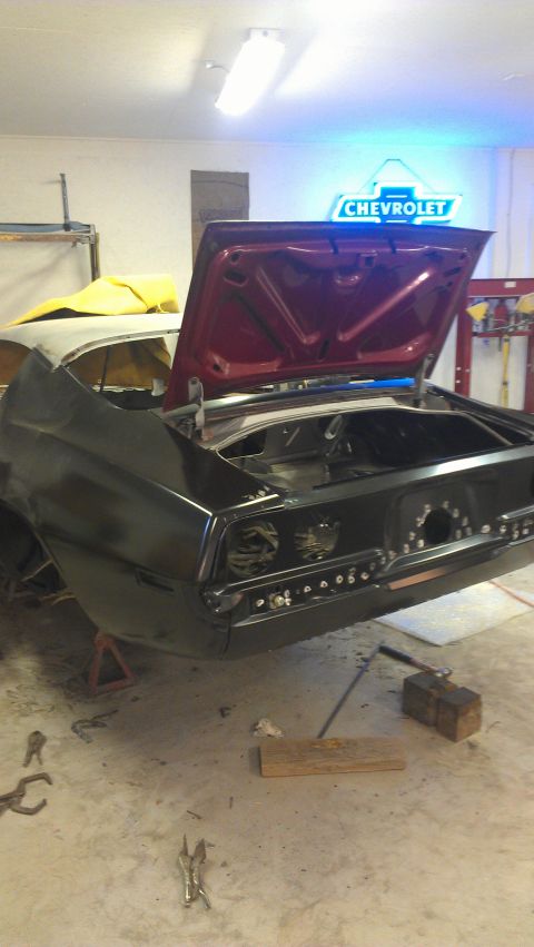1980 Pontiac Trans Am - Car body in a workshop with the trunk open. A Chevrolet sign is visible in the background.