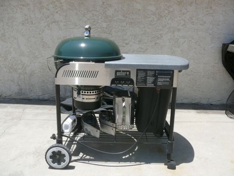 1988 Ford Bronco - A Weber grill sits on a concrete patio in front of a textured wall.