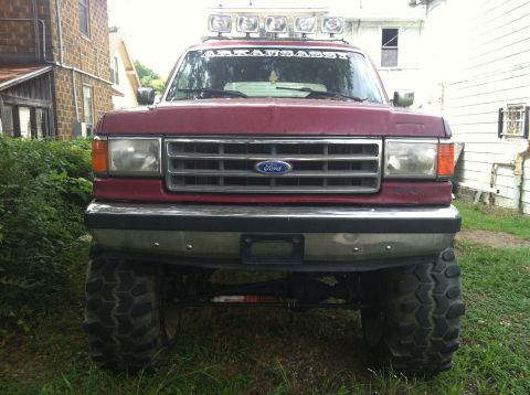 1991 Ford Bronco - This 1991 Ford Bronco features large off-road tires and a light bar mounted on the roof.