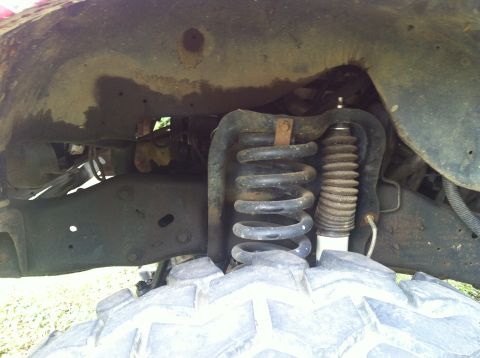 1991 Ford Bronco - Front suspension components and tire of a vehicle are shown in this close-up view.