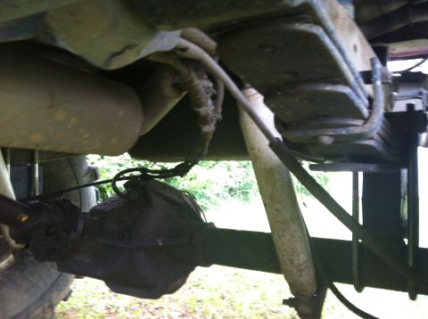 1991 Ford Bronco - Close-up of rear axle and suspension parts on a vehicle.