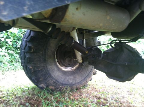 1991 Ford Bronco - Close-up of the rear axle assembly and driveshaft of an off-road vehicle.