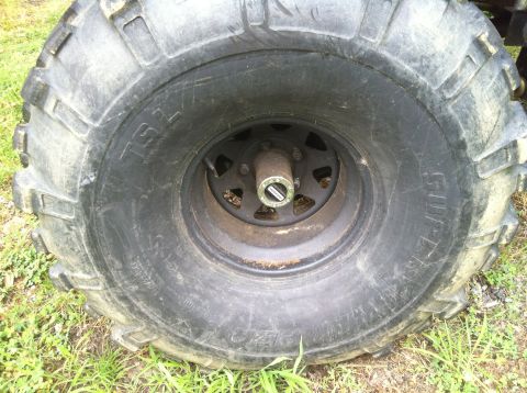 1991 Ford Bronco - Close-up of an off-road tire and wheel hub, showing 'TSL' and 'SUPER' markings on the tire sidewall.