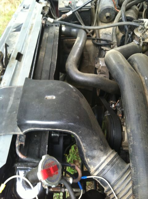 1991 Ford Bronco - Close-up view of the engine compartment of a 1991 Ford Bronco, highlighting various mechanical components.