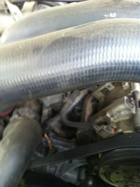1991 Ford Bronco - Close-up view of engine bay components, including hoses and belts, with a SuperMotors.net watermark visible.