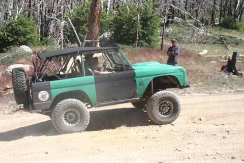 1991 Ford Bronco - This modified Ford Bronco is seen off-road with a two-tone paint job and large tires.