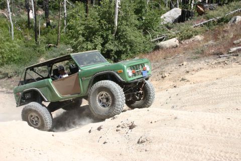 1991 Ford Bronco - Modified first-generation Ford Bronco navigating an off-road trail.