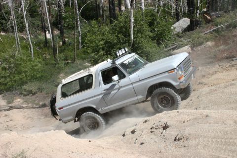 1991 Ford Bronco - This 1978 Ford Bronco navigates a steep, dusty incline in a wooded area.