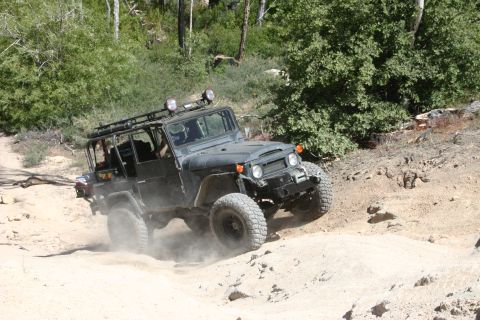 1991 Ford Bronco - This Toyota Land Cruiser FJ40 kicks up dust while navigating a off-road path.