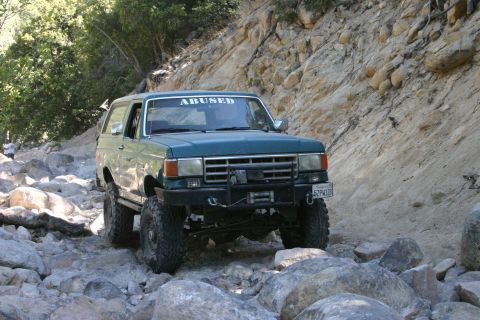 1991 Ford Bronco - This modified Ford Bronco is navigating a rocky off-road trail.