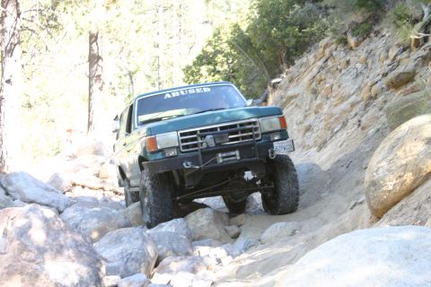 1991 Ford Bronco - This modified Ford Bronco is shown off-roading on a steep, rocky incline.