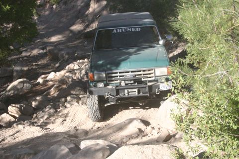 1991 Ford Bronco - This 1991 Ford Bronco is tackling a challenging off-road course with rocky obstacles.