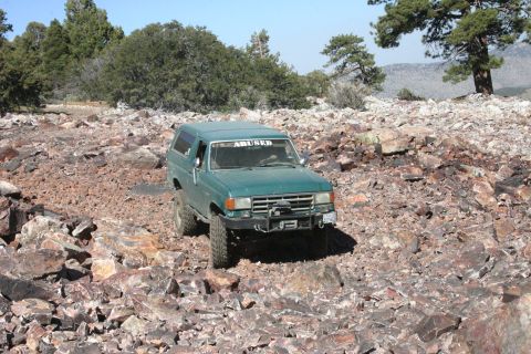 1991 Ford Bronco - This 1991 Ford Bronco navigates a challenging rocky path, displaying its off-road capabilities.